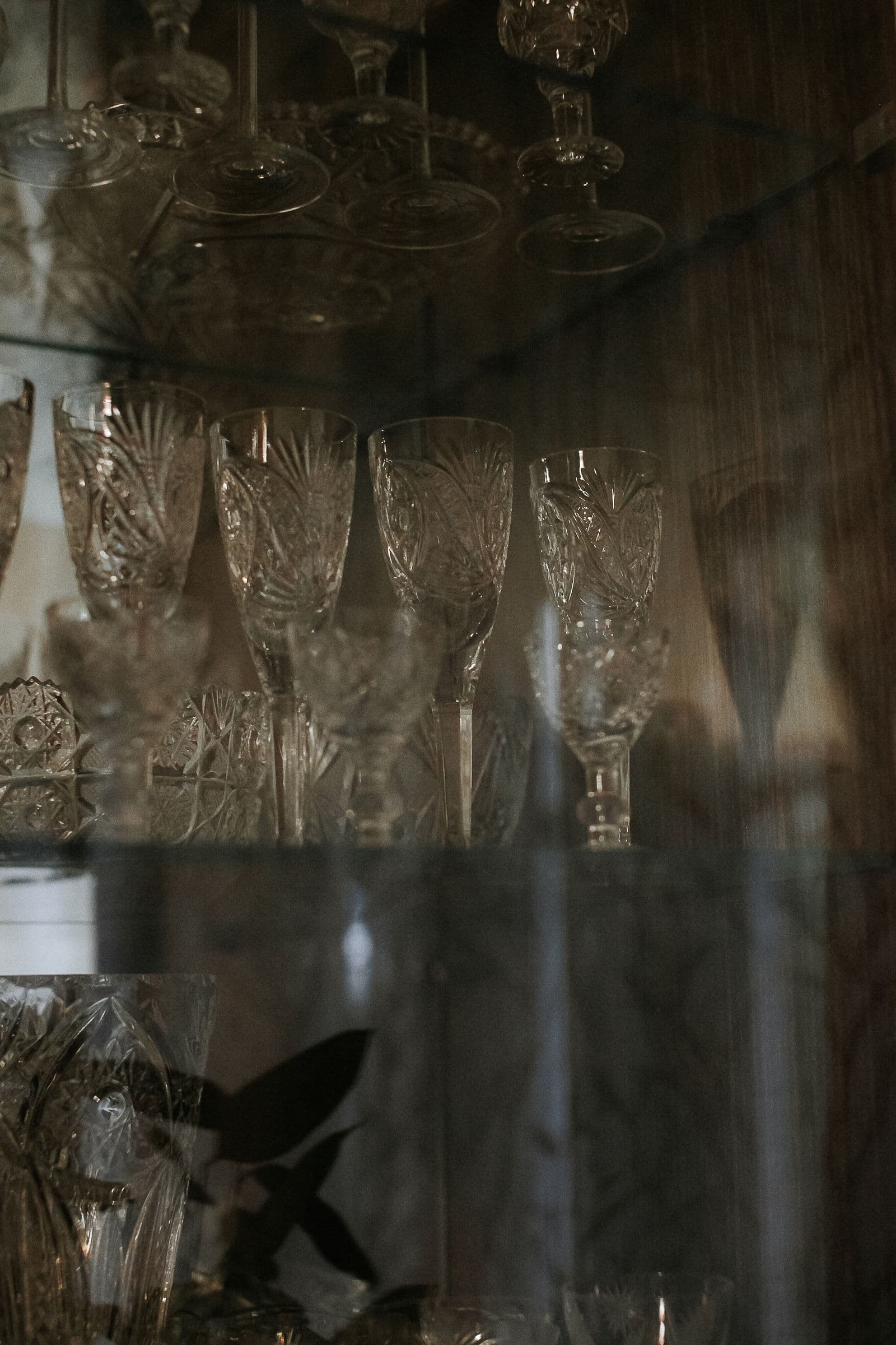 Vintage cut-crystal glassware arranged on a display shelf