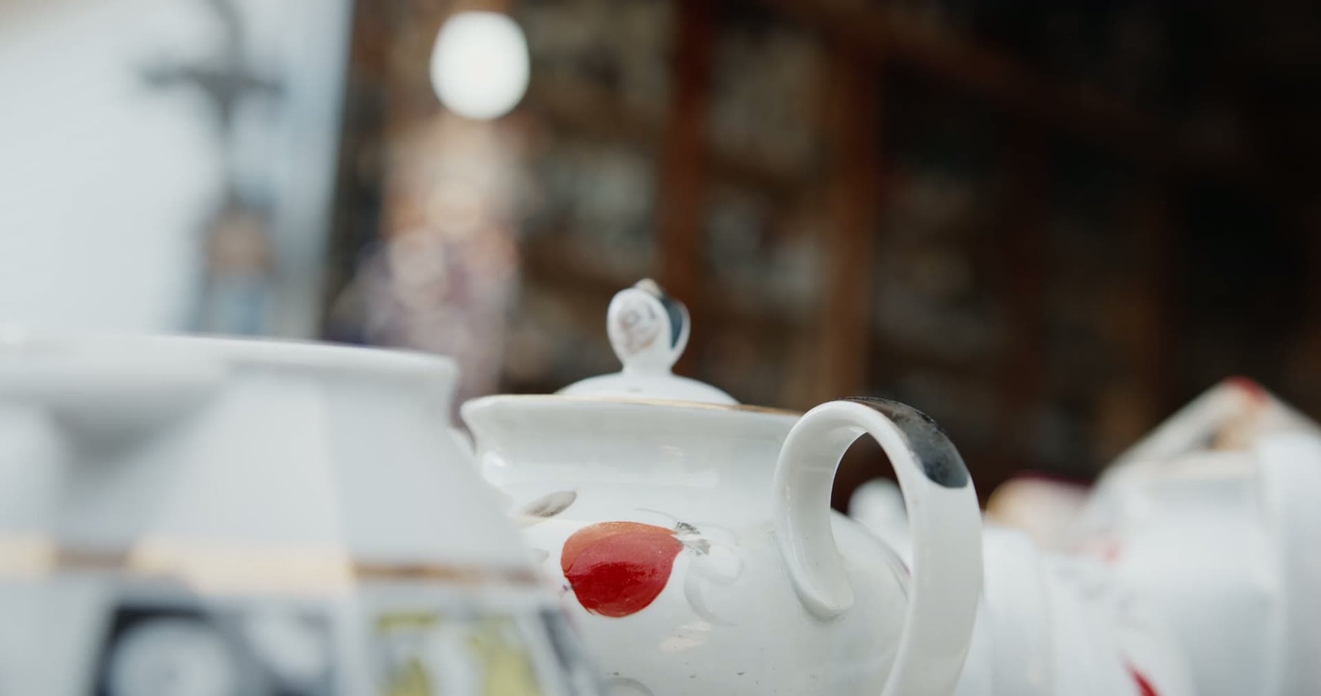 Vintage china teapot and cups on a shelf inside the antique mall